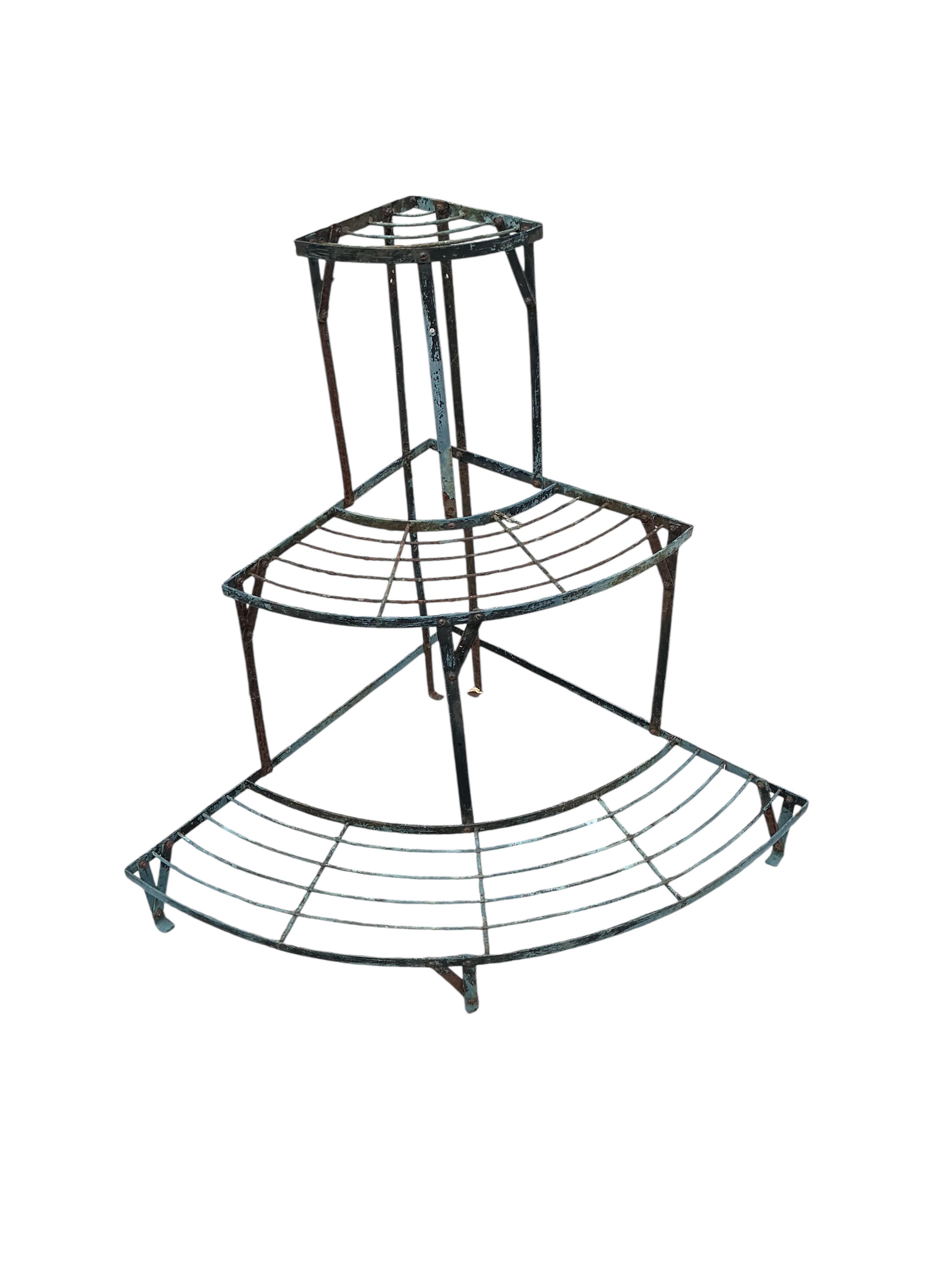 A wrought iron three section three tier pot stand, width 108cm, height 75cm